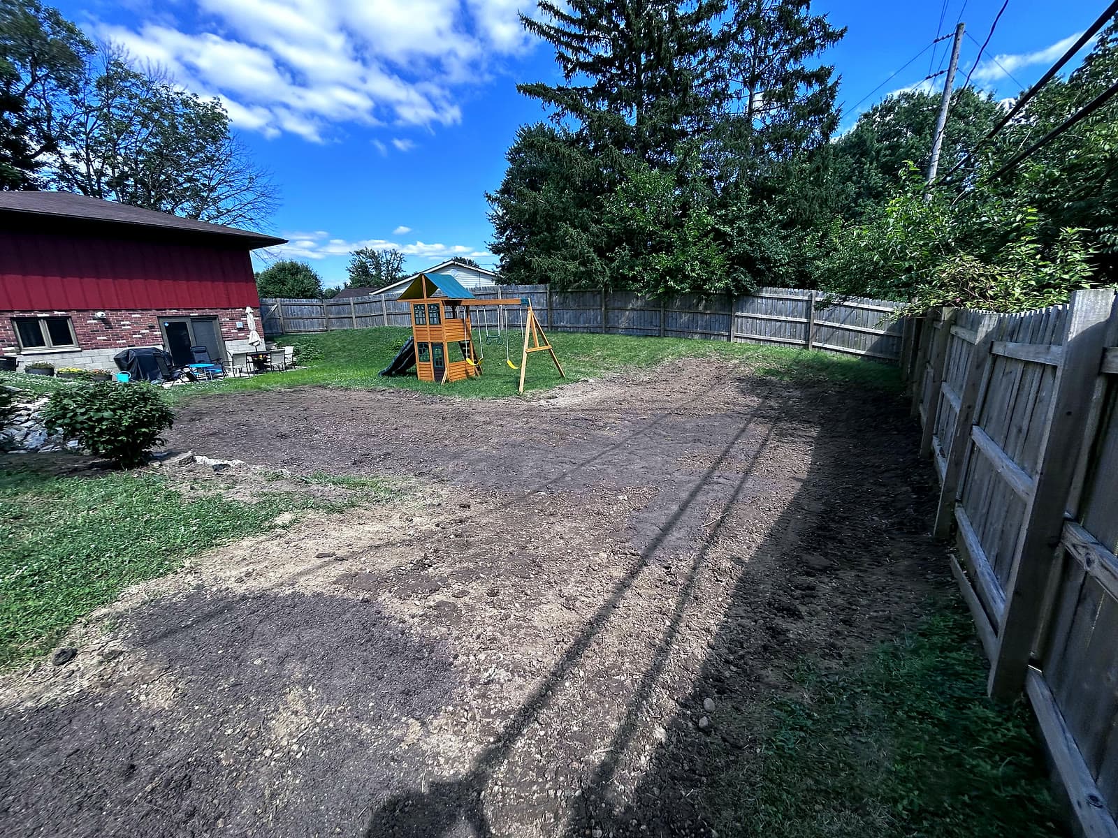Overgrown backyard cleared & graded — after