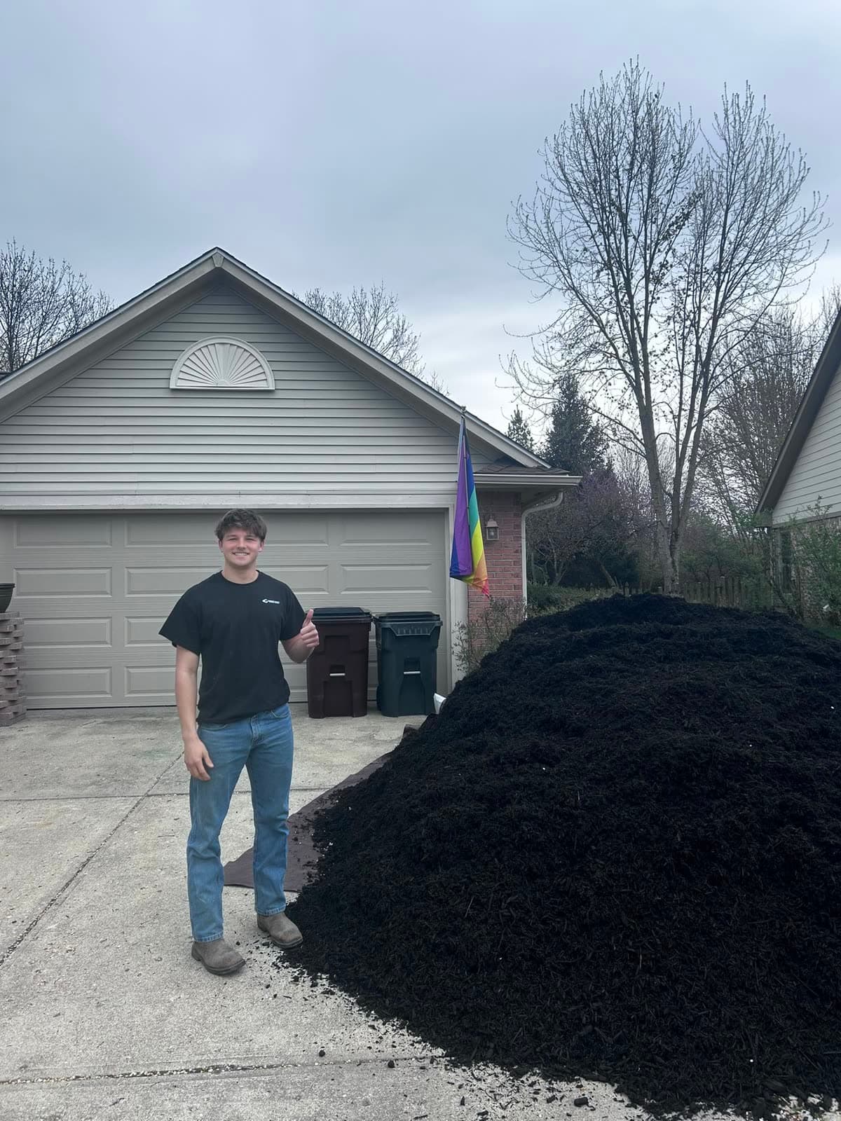 Larson Beekhuizen next to 10 cubic yards of black mulch he installed